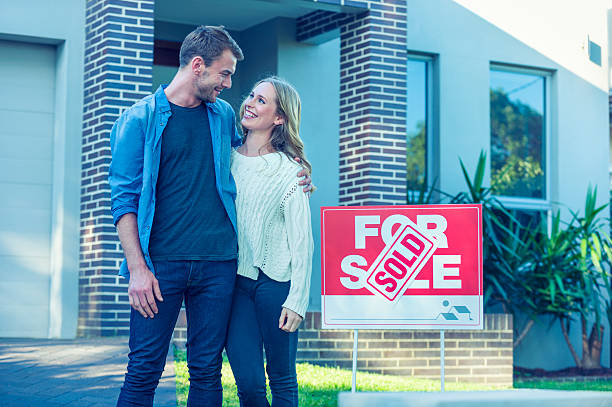 istock Couple standing in front of a new home. 505993164
