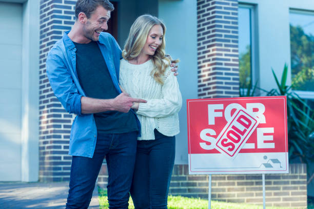 istock Couple standing in front of a new home. 505993420