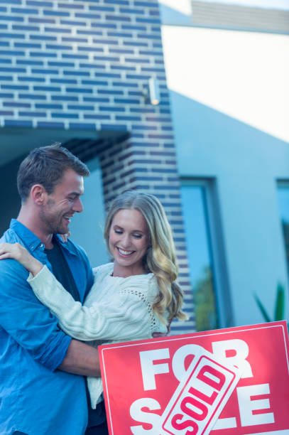 istock Couple standing in front of a new home. 505993638