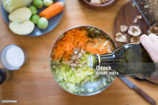 Pouring Olive Oil From Bottle Onto Salad Stock Photo - Download Image Now - Cooking, Olive Oil, Personal Perspective