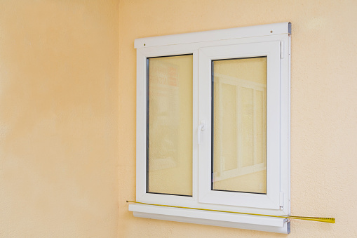 Sample of manufactured plastic window on the wall, ready to install