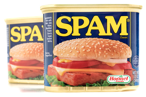 Miami,Florida, USA - June 1, 2015: Two cans of SPAM isolated on a white background. Spam stands for Spiced Pork and Ham, which is a canned precooked meat product. It is made by the Hormel Foods Corporation and was introduced in 1937.