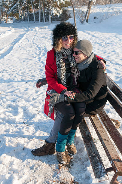 istock Couple sitting on a bench in a park in Winter 505996702