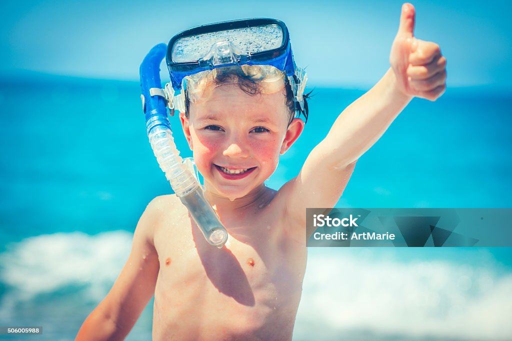Child on the beach Happy little boy with scuba mask on the beach Scuba Mask Stock Photo
