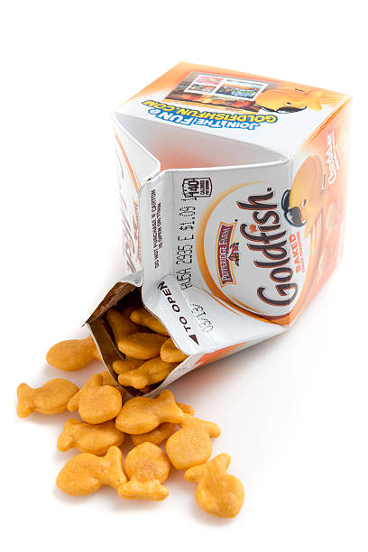 Goldfish baked snack crackers Miami, Florida,USA - June 1, 2015: 2 oz (57grams) package of Pepperidge Farm Goldfish baked snack crackers on white background. Pepperidge Farm is a commercial bakery in the U.S. founded in 1937 by Margaret Rudkin, who named the brand after her family's property in Fairfield, Connecticut, which in turn was named for the pepperidge tree, Nyssa sylvatica. It is based in Norwalk, Connecticut. In 1961, it was acquired by Campbell Soup Company. goldfish snack stock pictures, royalty-free photos & images