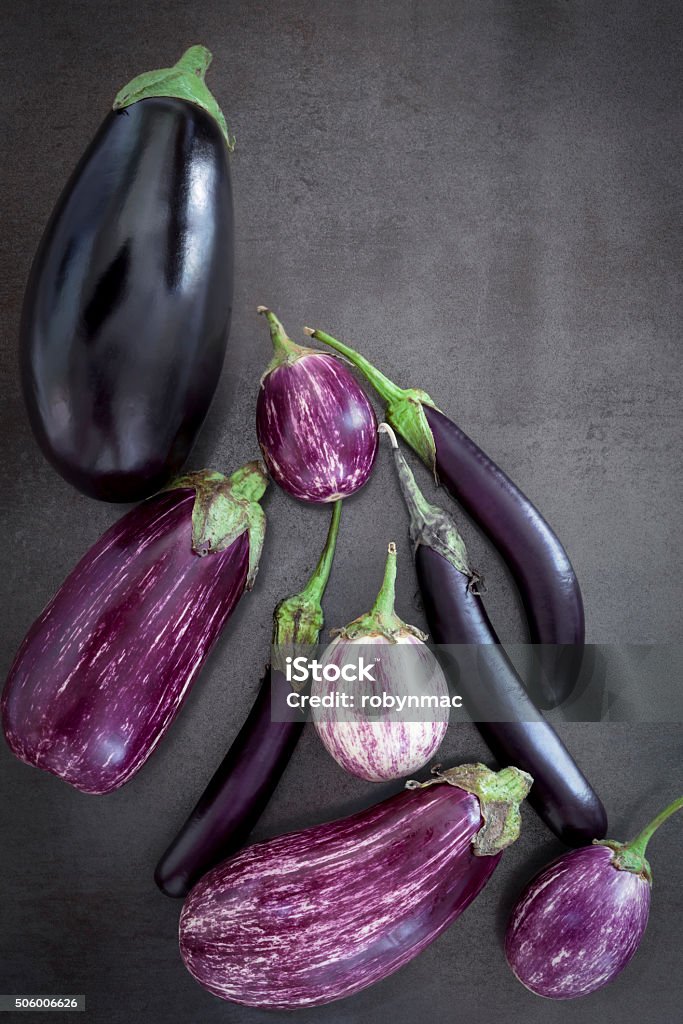 Eggplant Varieties on Slate Overhead View Eggplant varieties on black slate background.  Overhead view. Eggplant Stock Photo