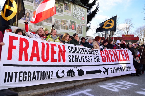 Graz / Austria - January 17, 2016: Women protestors at protest rally by local residents against the construction of refugee shelters located in a residential area at Kirchner barracks in Graz. The protest rally was organized by a local initiative and the identitarian movement in Austria.