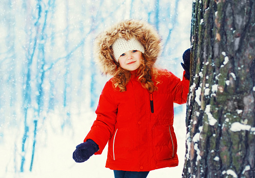 Little girl child walking in snowy winter day