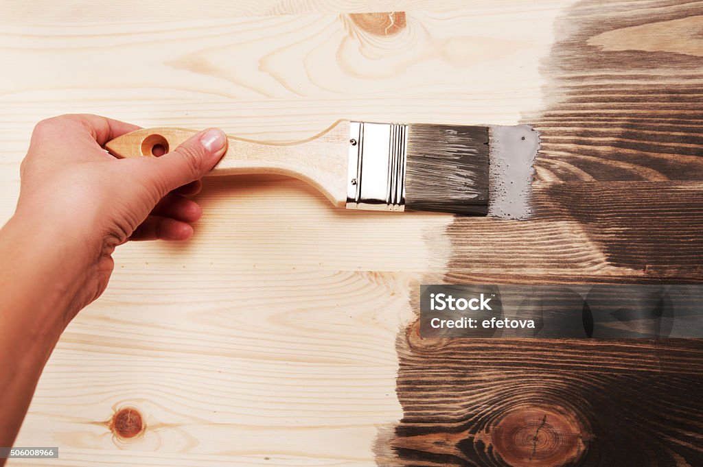 Hand painting on wooden table Hand painting grey color on wooden table use for home decorated. House renovation. Half - painted surface. Smear of paint brush Backgrounds Stock Photo