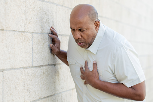 African American man holding his chest.