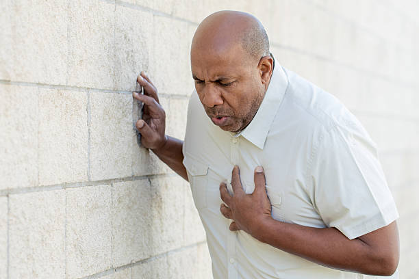 Man Having Chest Pains African American man holding his chest. terrified stock pictures, royalty-free photos & images