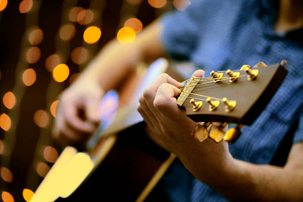 istock Man playing an acoustic guitar during a concert 506009172