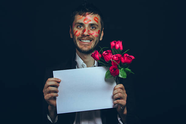 istock attractive guy with kisses on his face, Valentine's Day 506009648