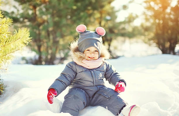 istock Cheerful smiling little child playing on snow in winter day 506010680