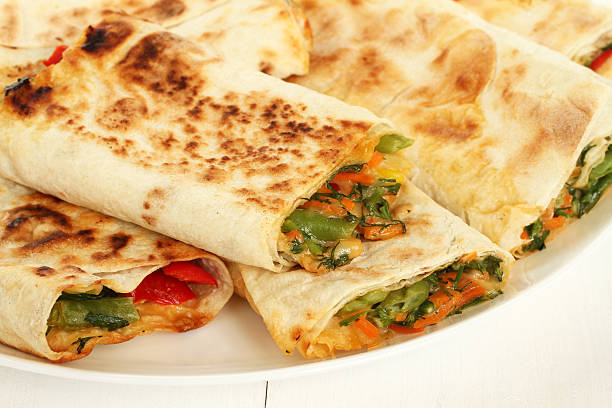 istock Roasted lavash with red sweet pepper, herbs and cheese inside 506012298