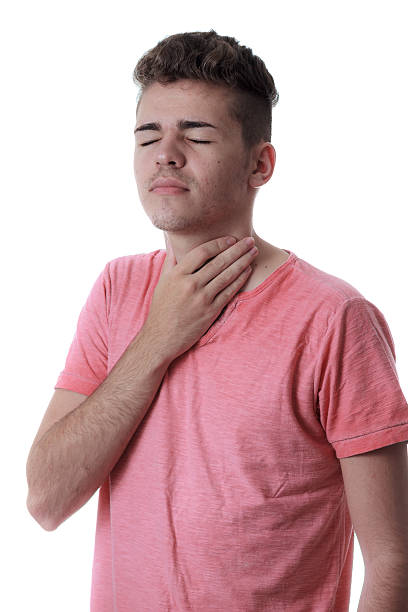 istock Young man holding the neck isolated on white background. 506012498