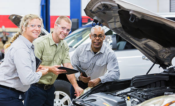 istock Team of multi-racial auto mechanics working on a car 506016008