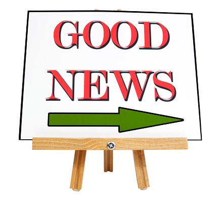 Good News announcement message with arrow on wood presentation easel.