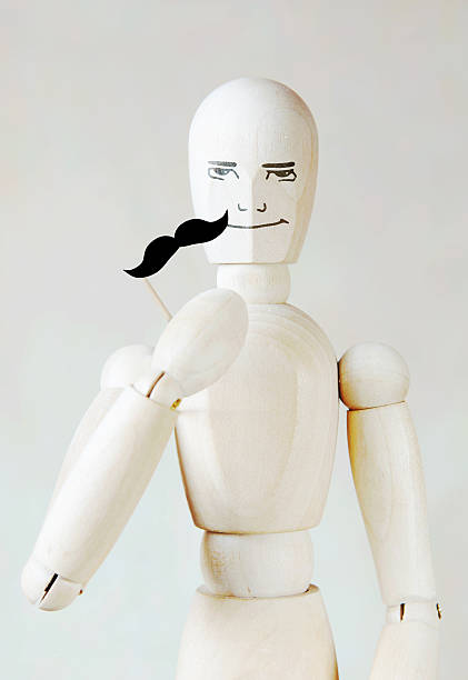istock Wooden puppet with fake mustache 506018902