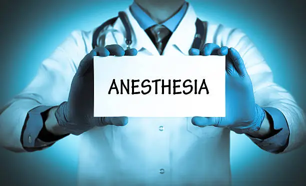 Doctor keeps a card with the name of the diagnosis – anesthesia. Selective focus. Medical concept.