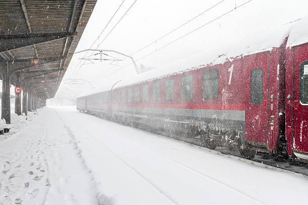 Delayed train waiting at the station during a snow storm