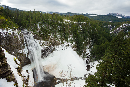 Salt Creek Falls on Willamette Pass in Oregon near Eugene during the winter with ice and frozen water crystals behind the waterfall.