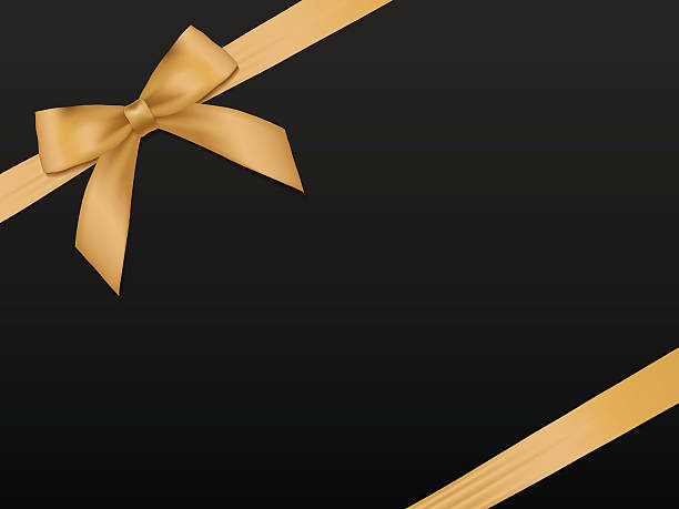 istock Gold Bow with ribbons. Holiday gold satin ribbon on black 506032628