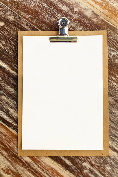 Blank clip on menu on wooden background stock photo