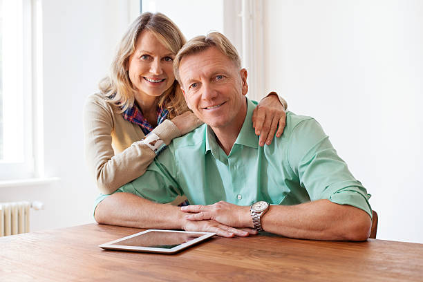 istock Happy mature couple with digital tablet at home 506033658
