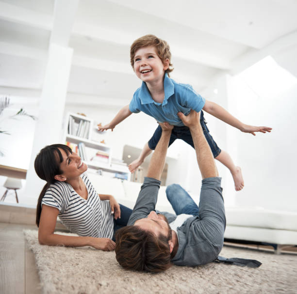 posso volare. - floor two parent family couple home interior foto e immagini stock