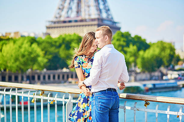 istock Young romantic couple kissing near the Eiffel tower 506060418