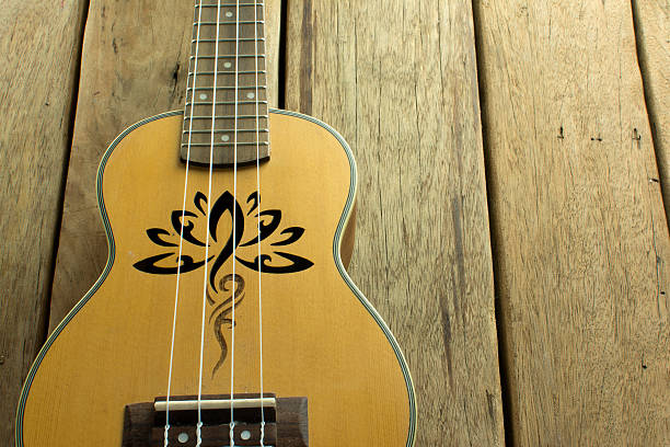 istock Ukulele, which rests on a wooden table. 506061344