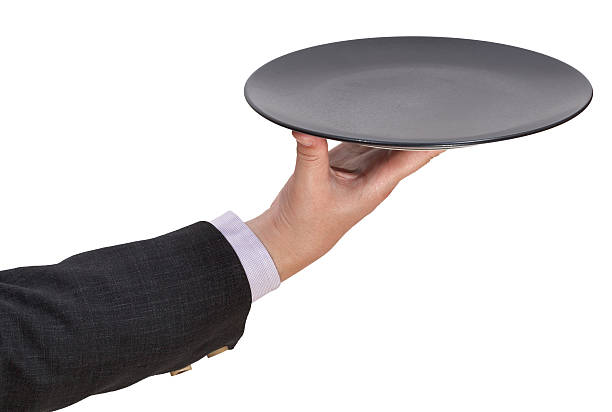 istock above view of hand with empty flat black plate 506063327