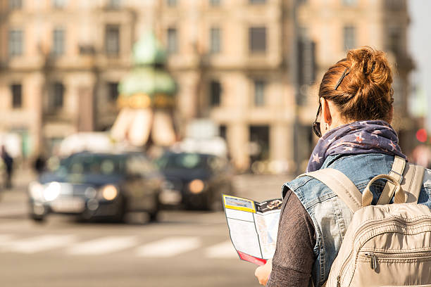 istock Woman looking at map in the city 506064218