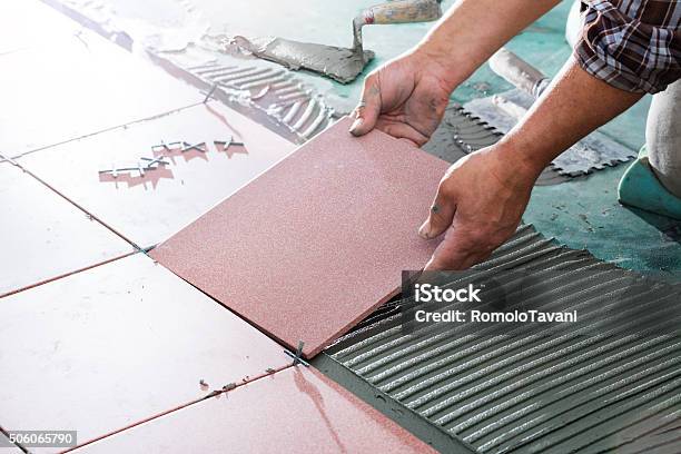 Installing Tiles Professional Worker Stock Photo - Download Image Now - Tiled Floor, Flooring, Tile