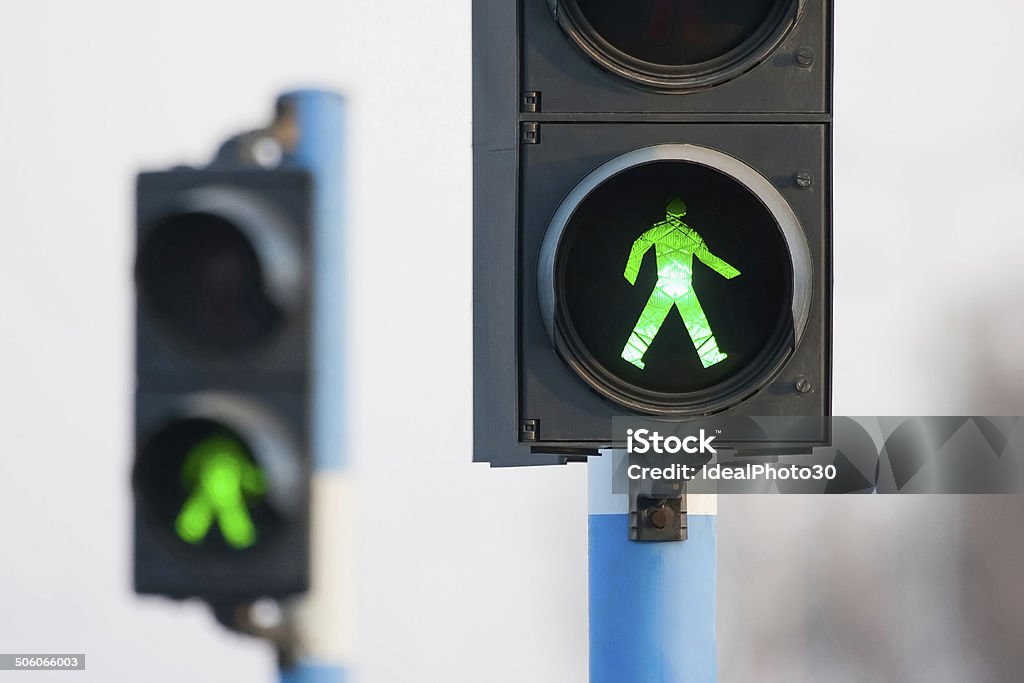 Two green lights for pedestrians Green lights for pedestrians on two semaphores in traffic. Green Light - Stoplight Stock Photo