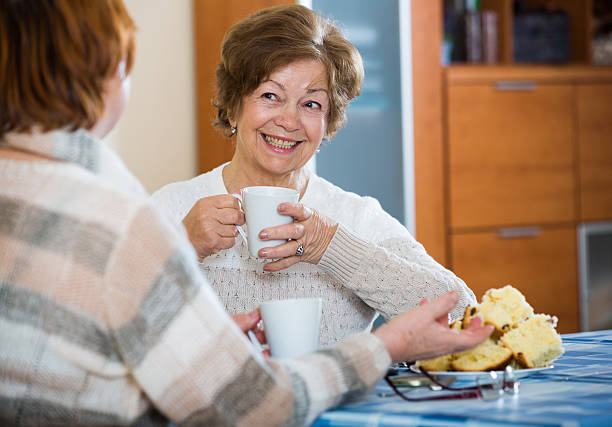 istock Positive female pensioners drinking coffee and chatting 506066052
