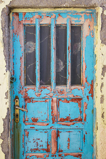 istock Old rusty wooden door with textured structure 506066424