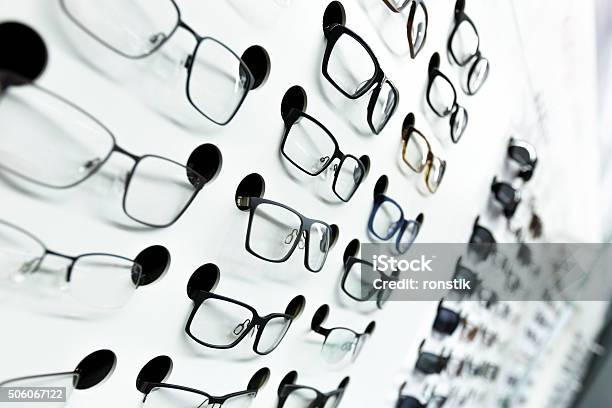 Optical Store Wall Of Many Fashionable Eyeglasses Stock Photo - Download Image Now - Arts Culture and Entertainment, Black Color, Choice