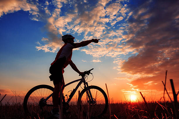 istock Man Cyclist with bike on sunset 506068800
