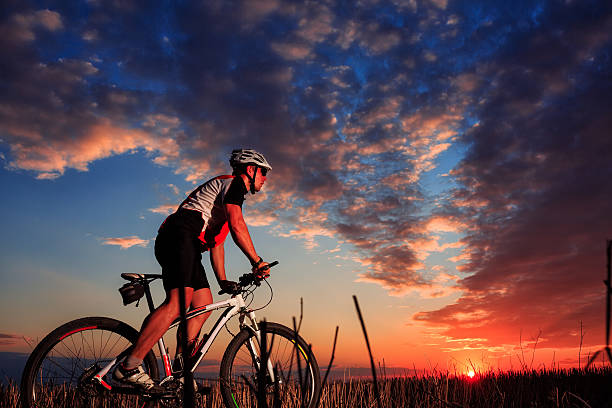 istock Man Cyclist with bike on sunset 506068882