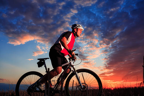 istock Man Cyclist with bike on sunset 506068912