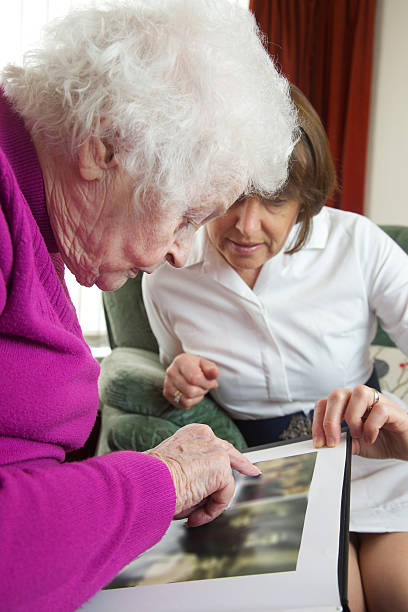 istock Care worker nurse visiting and caring for an elderly client 506069050