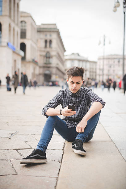 istock Young handsome alternative dark model man sitting outdoor in the 506069538