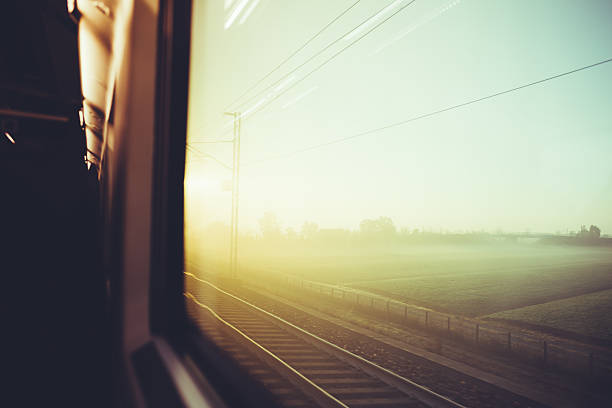 istock Blurred vintage filtered countryside view by a train window 506071018