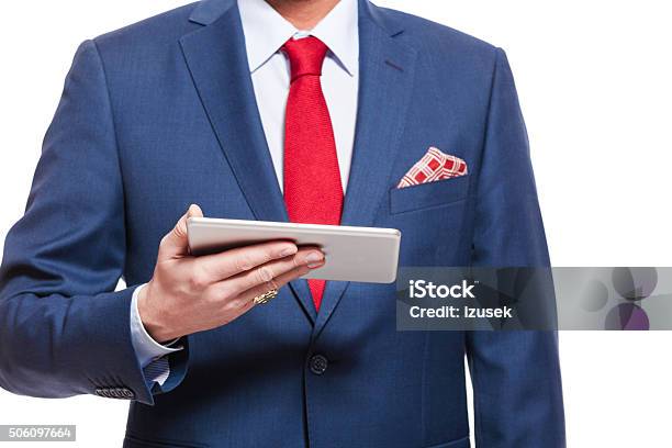 Close Up Of Elegant Businessman Wearing Suit Holding Digital Tablet Stock Photo - Download Image Now