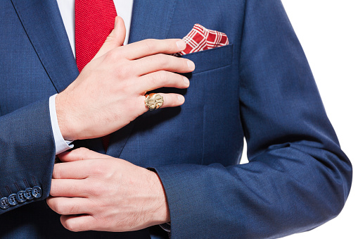 Elegant busienssman wearing navy blue jacket, red tie and pocket square. Unrecognizable person, part of, close up of hands.