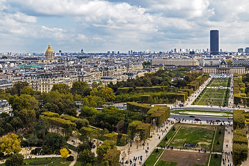 Aerial view on Champ de Mars from Eiffel tower, with Montparnasse tower and Dome des Invalides in Paris, France.