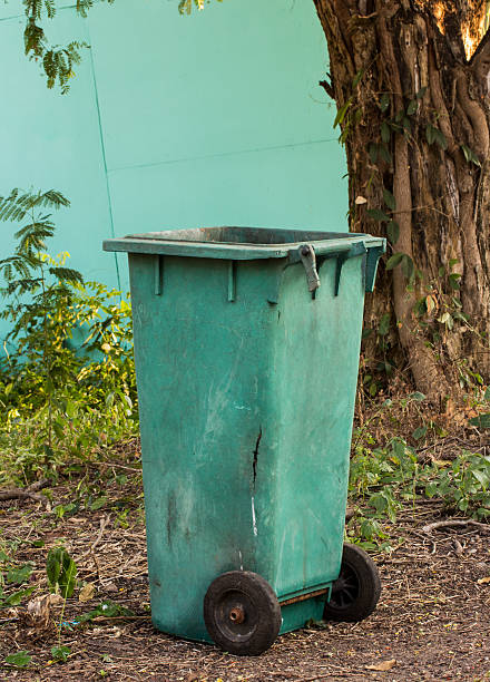 istock green trashcan in the park 506101828