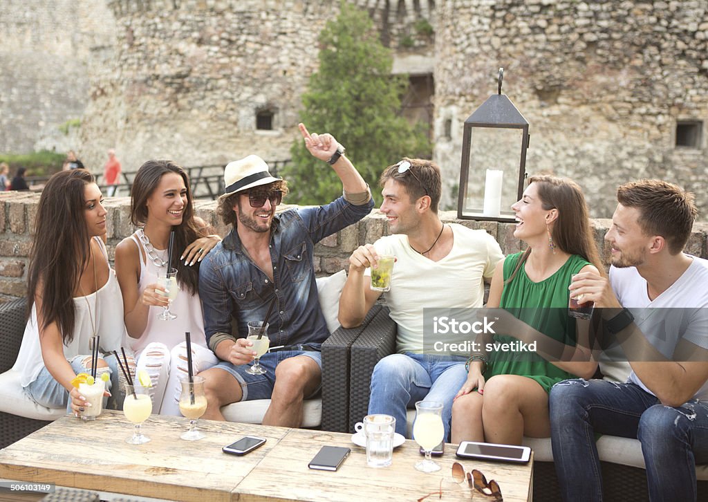 Friends having fun outdoors. Friends having fun at the bar outdoors, drinking cocktails. 20-29 Years Stock Photo